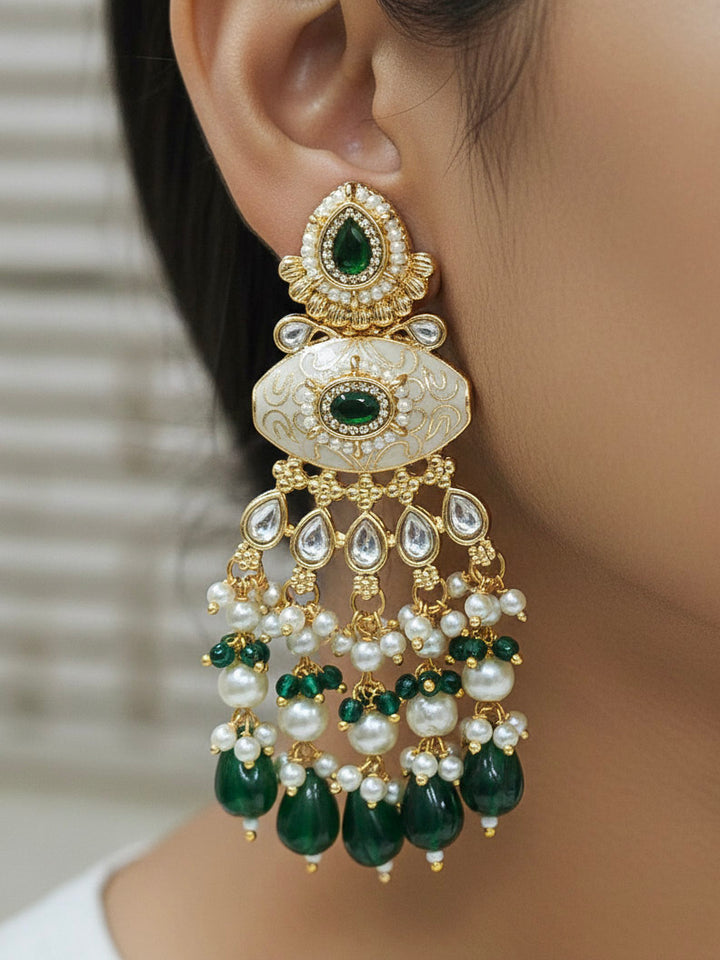 Close-up of a woman wearing an ornate traditional Dark Green Rajwadi gold Long jewellery set and earrings  with Pearls, Beads, Meenakari and Moissanite Kundan. Woman styled in a royal Rajwadi artificial necklace set for a traditional Indian wedding. Reception party look featuring a statement Rajwadi necklace.