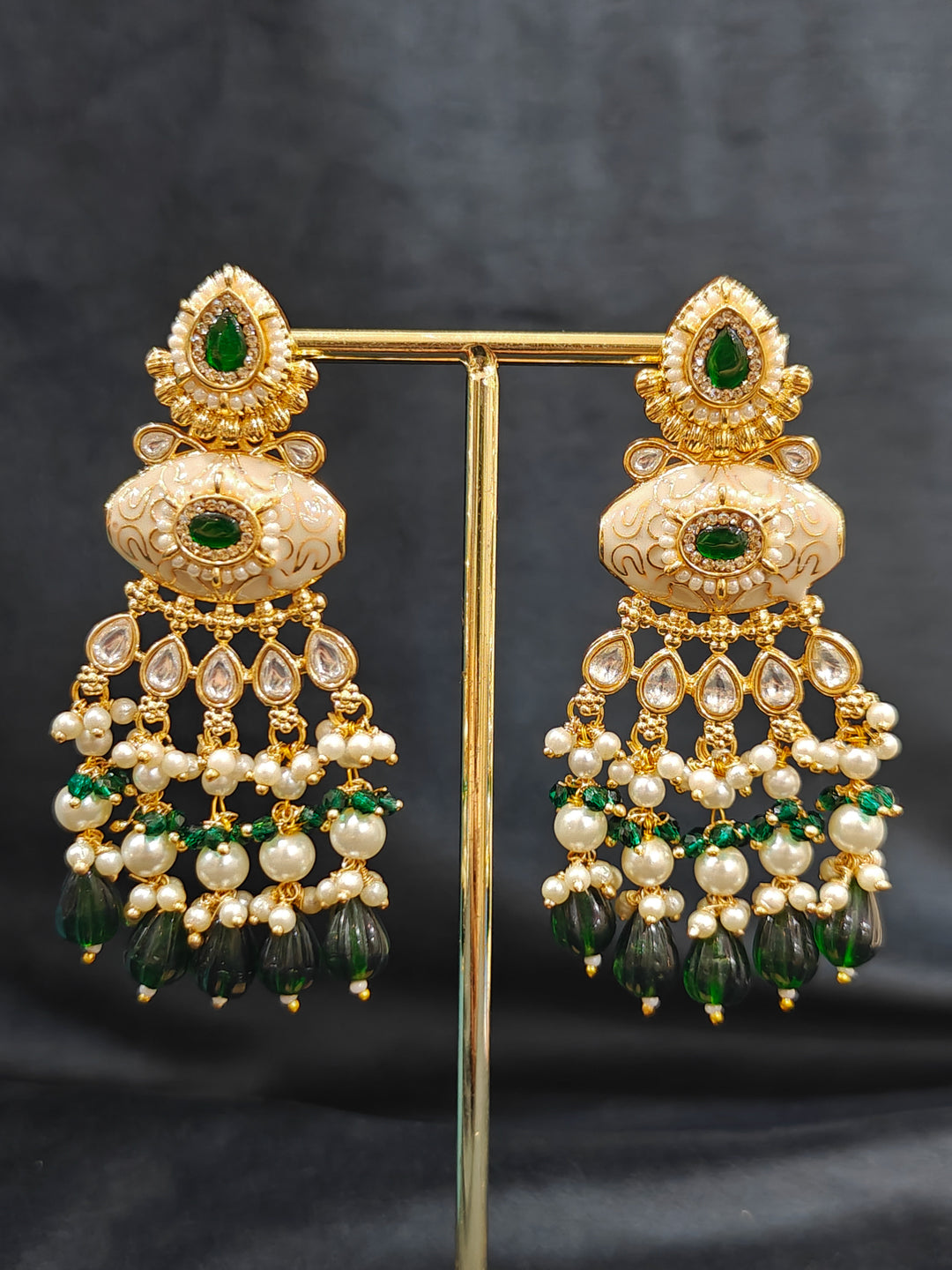 Close-up of a woman wearing an ornate traditional Dark Green Rajwadi gold Long jewellery set and earrings  with Pearls, Beads, Meenakari and Moissanite Kundan. Festive Diwali outfit enhanced with a Rajwadi artificial necklace. Close-up of a premium Rajwadi artificial necklace under 10000. Perfect Rajwadi necklace set for weddings and festivals.