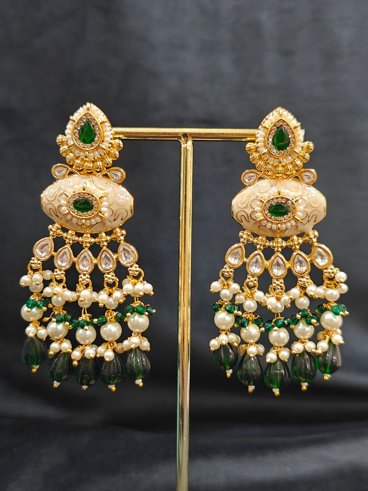 Close-up of a woman wearing an ornate traditional Dark Green Rajwadi gold Long jewellery set and earrings  with Pearls, Beads, Meenakari and Moissanite Kundan. Festive Diwali outfit enhanced with a Rajwadi artificial necklace. Close-up of a premium Rajwadi artificial necklace under 10000. Perfect Rajwadi necklace set for weddings and festivals.