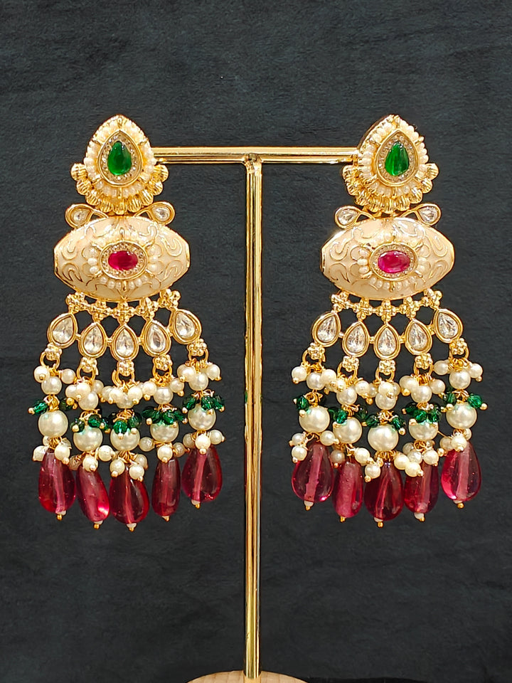 Close-up of an ornate traditional Ruby Pink and Green Rajwadi gold Long jewellery set and earrings  with Pearls, Beads, Meenakari and Moissanite Kundan. Festive look completed with a luxury Rajwadi imitation necklace. Close-up of a premium Rajwadi artificial necklace under 10000.