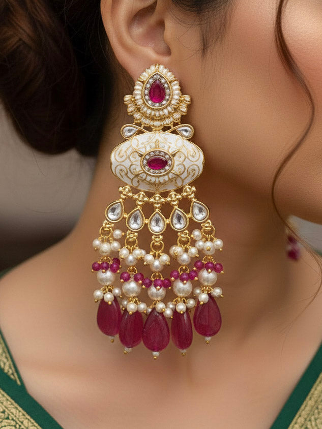 Close-up of a woman wearing an ornate traditional Ruby Pink Rajwadi gold Long jewellery set and earrings  with Pearls, Beads, Meenakari and Moissanite Kundan. Woman wearing a Rajwadi necklace for a reception function. Luxury imitation Rajwadi necklace worn for wedding celebrations.