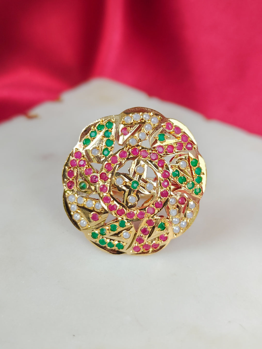 Close-up of an ornate traditional White, Multi-color jadau gold Ring with pearl and Color Stone. Close-up of handcrafted imitation Jadau ring for Festive wear. Perfect Jadau Ring for weddings and festivals.