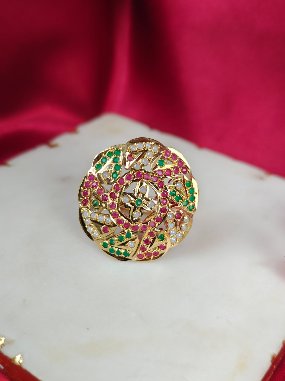 Close-up of an ornate traditional White, Multi-color jadau gold Ring with pearl and Color Stone. Close-up of handcrafted imitation Jadau ring for Festive wear. Perfect Jadau Ring for weddings and festivals.