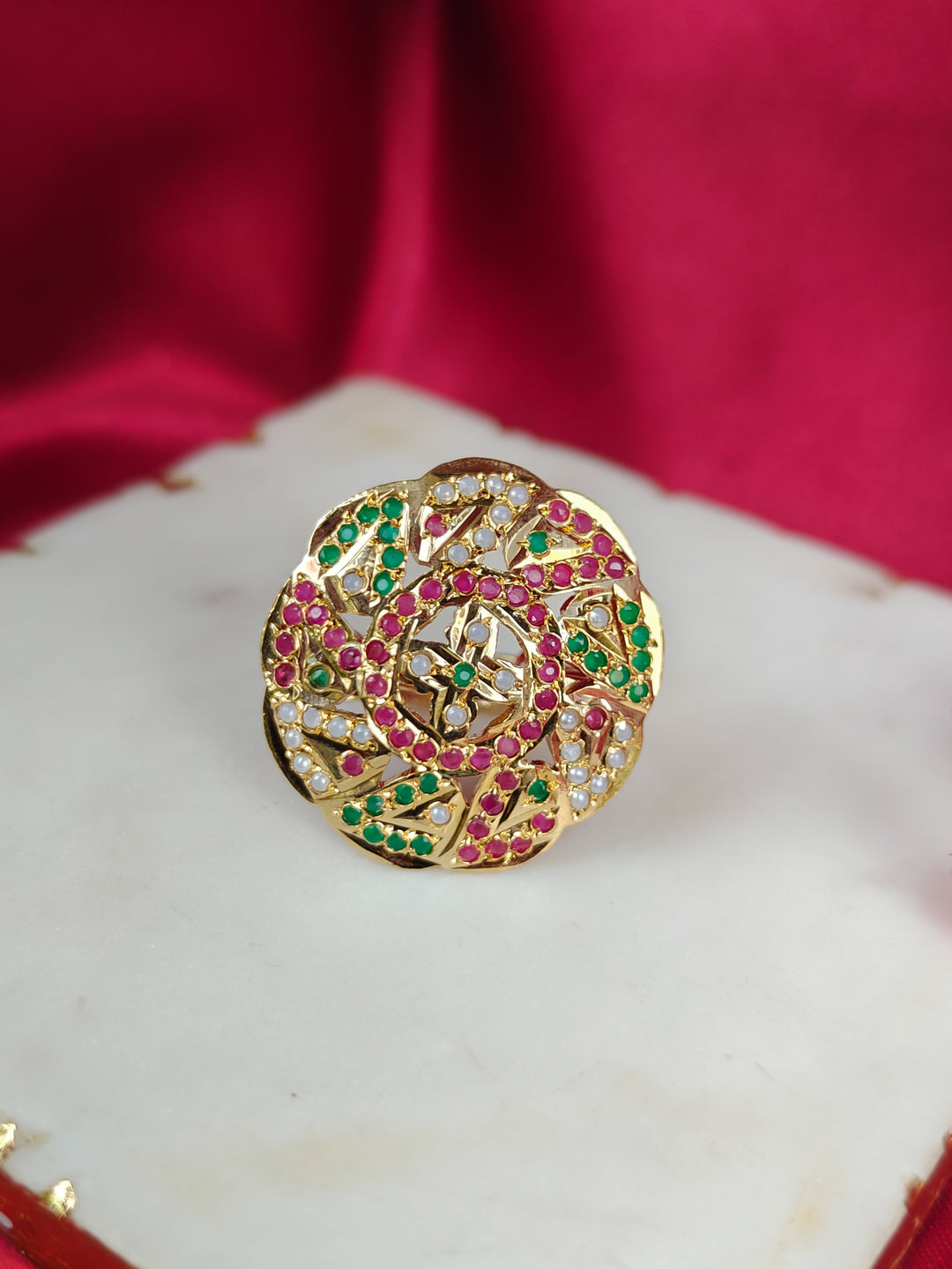 Close-up of an ornate traditional White, Multi-color jadau gold Ring with pearl and Color Stone. Close-up of handcrafted imitation Jadau ring for Festive wear. Perfect Jadau Ring for weddings and festivals.