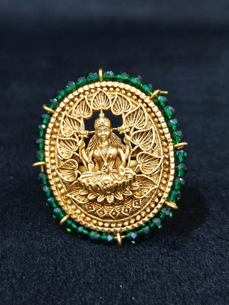 The Siddhi Ring featuring a traditional gold Ring with Goddess Laxmi in the middle, along with Green Crystal Beads, Bride showcasing a premium temple artificial Ring for wedding rituals. 
