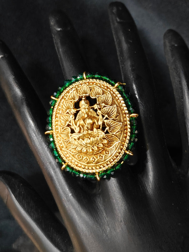 The Siddhi Ring featuring a traditional gold Ring with Goddess Laxmi in the middle, along with Green Crystal Beads, Bride showcasing a premium temple artificial Ring for wedding rituals. 