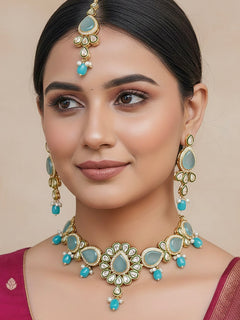 Close-up of a woman wearing an ornate traditional Sky Blue Choker jewellery set and earrings and maangtikka with Kundan, Monalisa Stone, American Diamonds, Beads and Reverse American Diamonds and tumble stones. A graceful woman wearing a trending Colored Stone necklace for a 2026 wedding celebration. Elegant wedding jewelry look featuring a premium artificial Colored Stone necklace.