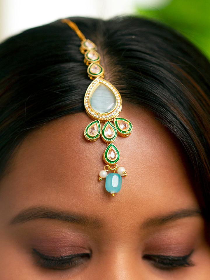 Close-up of a women wearing an ornate traditional Sky Blue Choker jewellery set and earrings and maangtikka with Kundan, Monalisa Stone, American Diamonds, Beads and Reverse American Diamonds and tumble stones. A graceful woman wearing a trending Colored Stone necklace for a 2026 wedding celebration. Elegant wedding jewelry look featuring a premium artificial Colored Stone necklace.