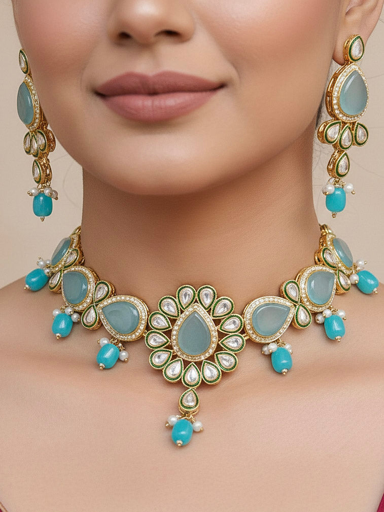 Close-up of a woman wearing an ornate traditional Sky Blue Choker jewellery set and earrings and maangtikka with Kundan, Monalisa Stone, American Diamonds, Beads and Reverse American Diamonds and tumble stones. A graceful woman wearing a trending Colored Stone necklace for a 2026 wedding celebration. Elegant wedding jewelry look featuring a premium artificial Colored Stone necklace.