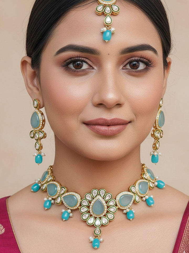 Close-up of a woman wearing an ornate traditional Sky Blue Choker jewellery set and earrings and maangtikka with Kundan, Monalisa Stone, American Diamonds, Beads and Reverse American Diamonds and tumble stones. A graceful woman wearing a trending Colored Stone necklace for a 2026 wedding celebration. Elegant wedding jewelry look featuring a premium artificial Colored Stone necklace.