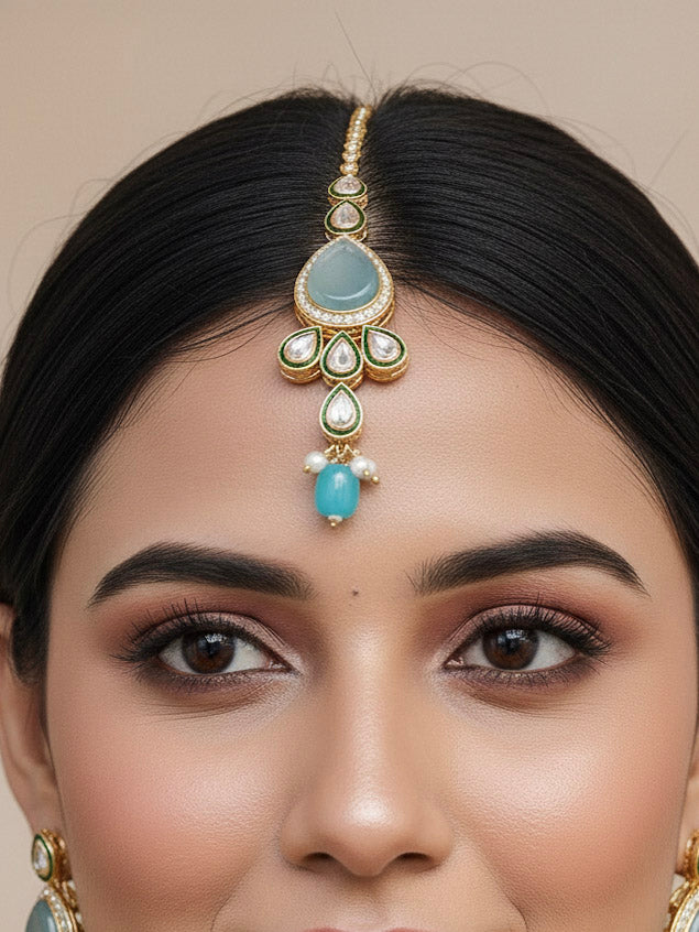 Close-up of a woman wearing an ornate traditional Sky Blue Choker jewellery set and earrings and maangtikka with Kundan, Monalisa Stone, American Diamonds, Beads and Reverse American Diamonds and tumble stones. A graceful woman wearing a trending Colored Stone necklace for a 2026 wedding celebration. Elegant wedding jewelry look featuring a premium artificial Colored Stone necklace.