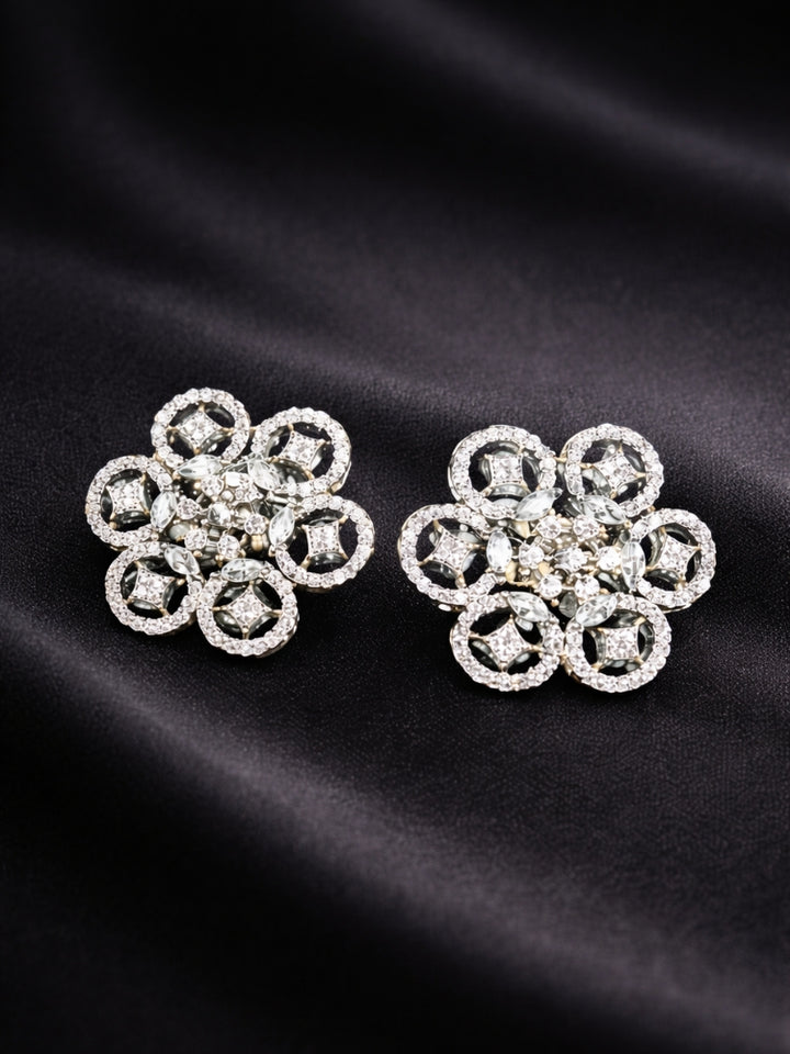 Close-up of an ornate Western (Silver Polish) Diamond Studs Earrings with American Diamond. Festive Diwali outfit styled with an American diamond artificial Earrings. Close-up shot of a high-quality American diamond artificial Earrings worn for festive celebrations.