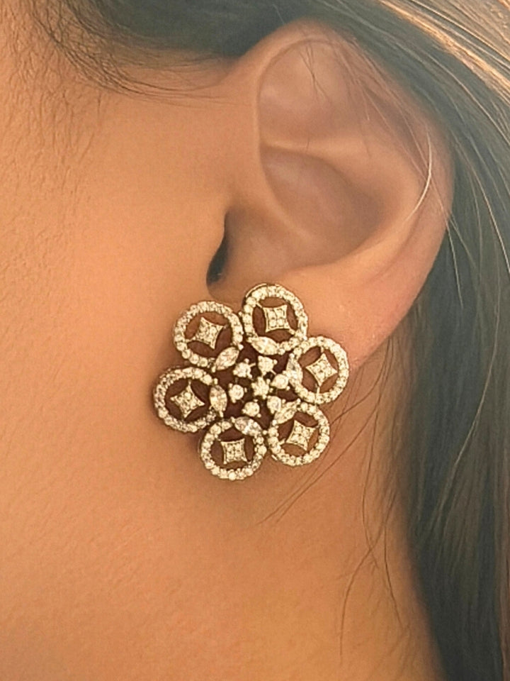 Close-up of a woman wearing an ornate Western (Silver Polish) Diamond Studs Earrings with American Diamond. Festive Diwali outfit styled with an American diamond artificial Earrings. Close-up shot of a high-quality American diamond artificial Earrings worn for festive celebrations.
