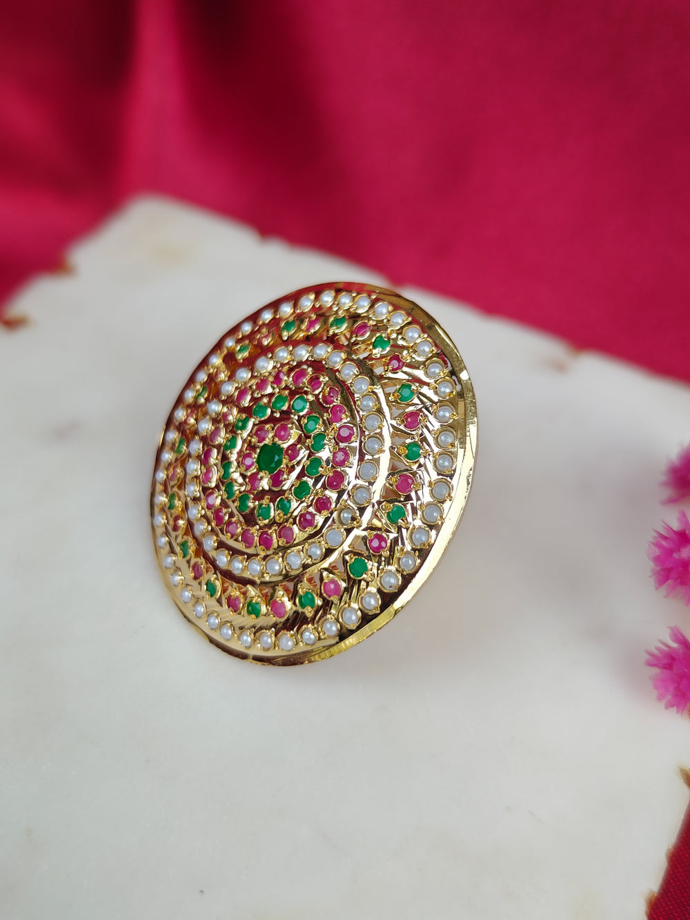Close-up of an ornate traditional White, Multi-color jadau gold Ring with pearl and Color Stone. Styling a premium imitation jadau ring with festive attire. Saree styling inspiration featuring an adjustable artificial Jadau ring.