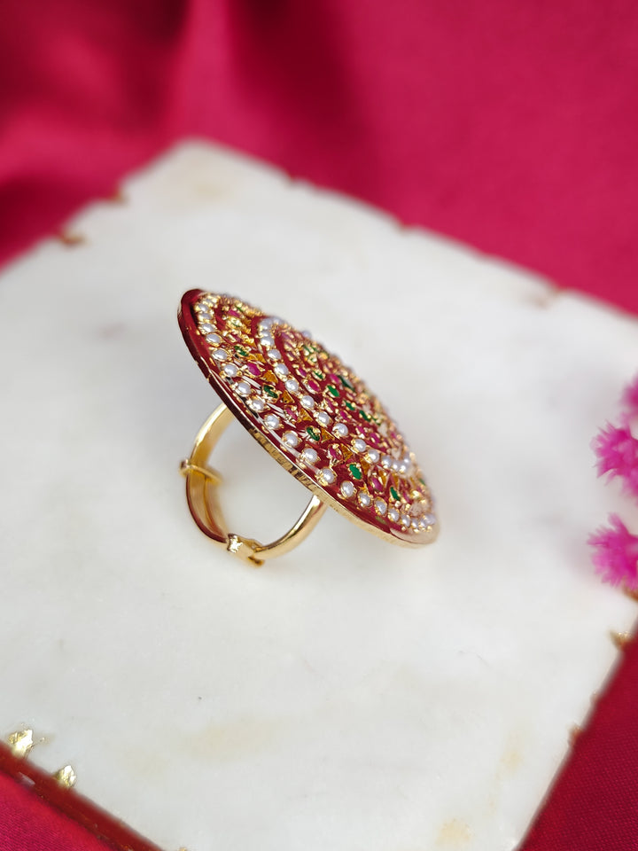 Close-up of an ornate traditional White, Multi-color jadau gold Ring with pearl and Color Stone. Styling a premium imitation jadau ring with festive attire. Saree styling inspiration featuring an adjustable artificial Jadau ring.