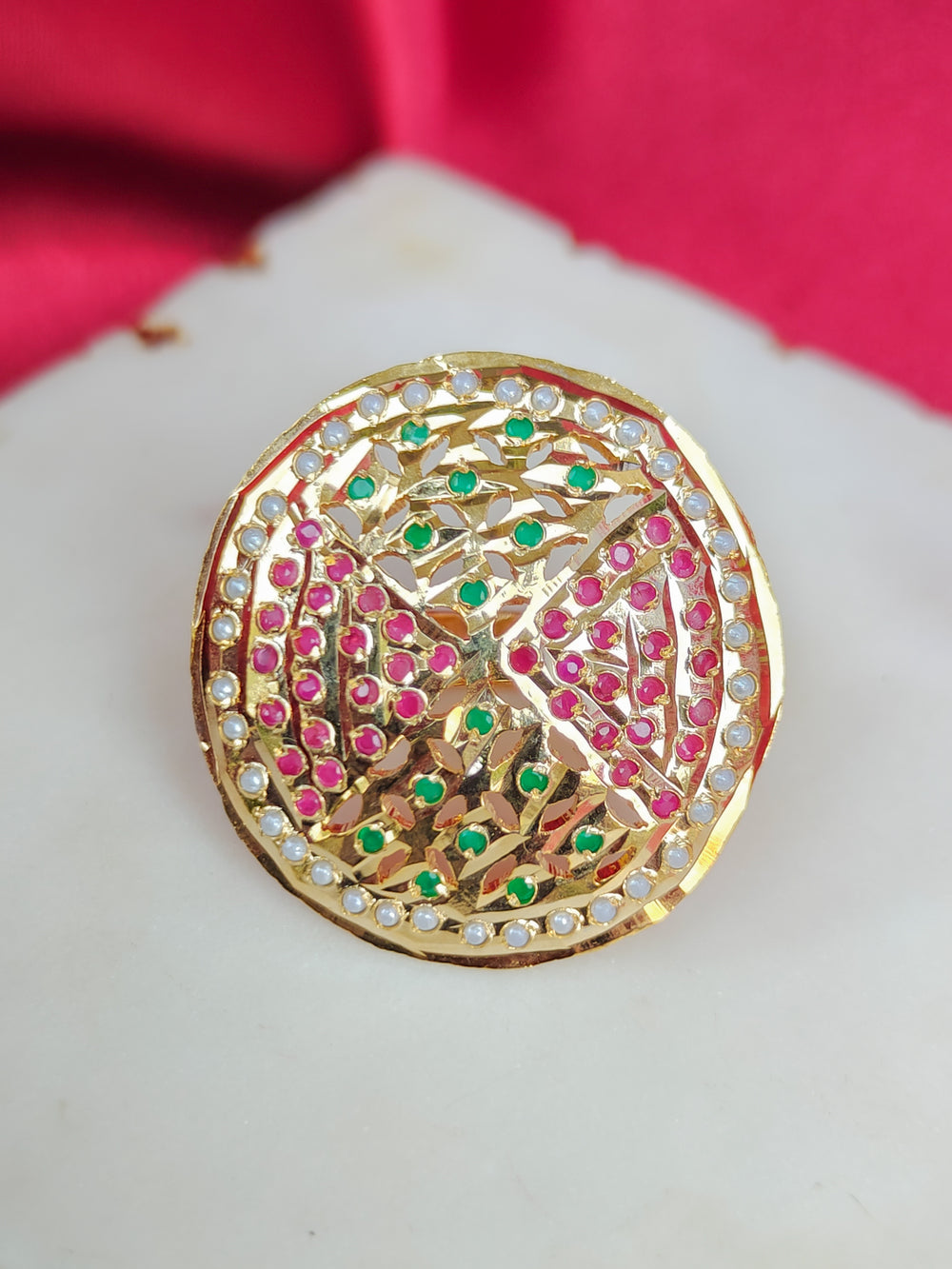Close-up of an ornate traditional White, Multi-color jadau gold Ring with pearl and Color Stone. Styling a premium imitation jadau ring with festive attire. Close-up of a high-quality imitation jadau ring with intricate detailing.