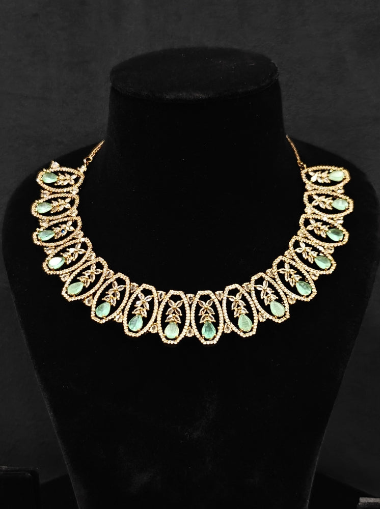 Close-up of an ornate Indo-Western American diamond and Colored Stone Collar jewellery set, earrings and maangtikka with American diamond and Colored Stone. A sparkling American diamond necklace for reception night.