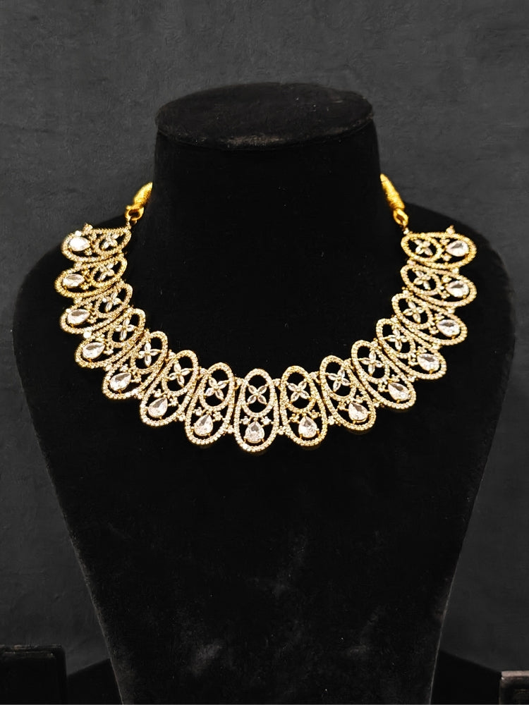 Close-up of an ornate Indo-Western American diamond Collar jewellery set, earrings and maangtikka with American diamond. A sparkling American diamond necklace for reception night.