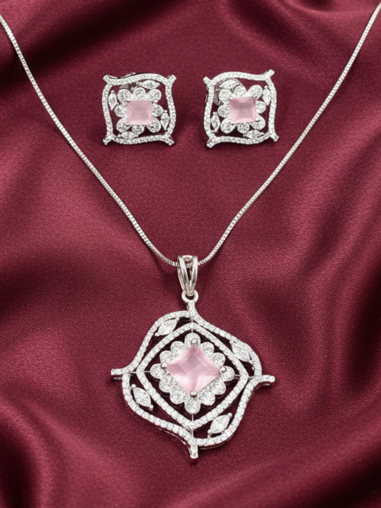 Close-up of a woman wearing an ornate Western (Silver Polish) Mint Pink Diamond Pendant set and earrings with American Diamond and Colored Stones. Party wear outfit completed with a lightweight American diamond Pendant Set. Close-up shot of a high-quality American diamond artificial Pendant worn for festive celebrations.