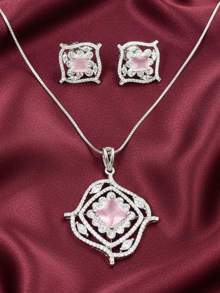 Close-up of a woman wearing an ornate Western (Silver Polish) Mint Pink Diamond Pendant set and earrings with American Diamond and Colored Stones. Party wear outfit completed with a lightweight American diamond Pendant Set. Close-up shot of a high-quality American diamond artificial Pendant worn for festive celebrations.