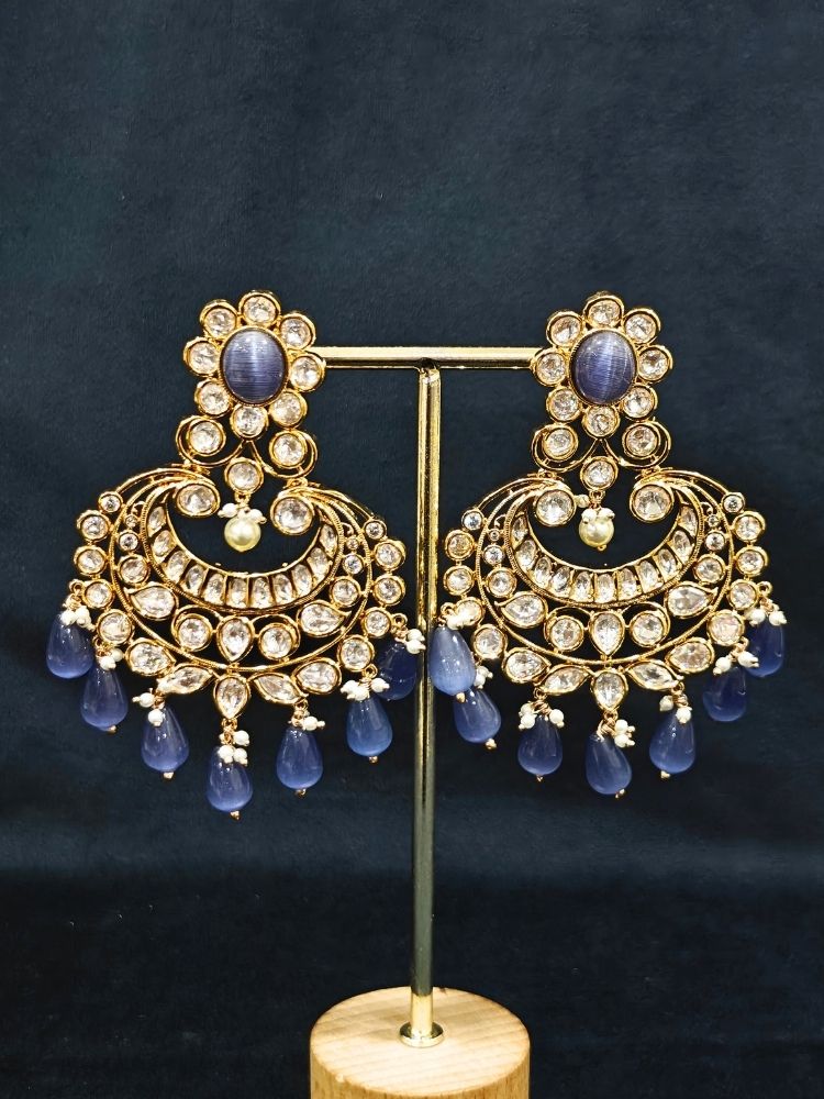 Close-up of an ornate traditional (Gold Polish) Lilac Long jewellery set and earrings with Polki,  Tumble Beads, Crystal Beads, Pearls and Colored Stone. Woman styling a premium Polki imitation necklace for wedding celebrations. Wedding guest outfit styled with an elegant Polki necklace set.