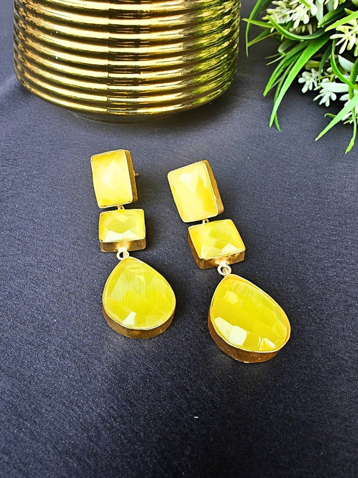 Close-up of an ornate Western Long Earrings with Yellow Colored Stone. Indo-western dress styled with lightweight artificial Colored Stone earrings. 