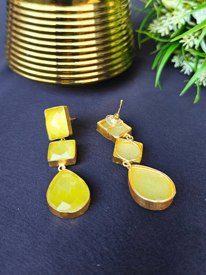 Close-up of an ornate Western Long Earrings with Yellow Colored Stone. Indo-western dress styled with lightweight artificial Colored Stone earrings. 