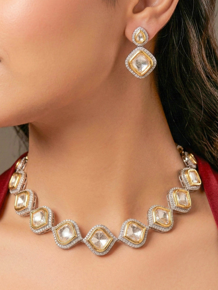 A women Wearing the Moissanite Susan Necklace Set—gold and silver Kundan necklace surrounded by American Diamonds, with matching earrings—gazing neutrally at the camera, effortlessly highlighting this luxury jewelry. Woman wearing trending Kundan artificial jewelry for wedding season in India. Festive saree styling with a premium artificial Kundan necklace.