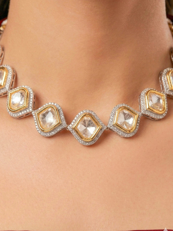 A women Wearing the Moissanite Susan Necklace Set—gold and silver Kundan necklace surrounded by American Diamonds, with matching earrings—gazing neutrally at the camera, effortlessly highlighting this luxury jewelry. Woman wearing trending Kundan artificial jewelry for wedding season in India. Festive saree styling with a premium artificial Kundan necklace.