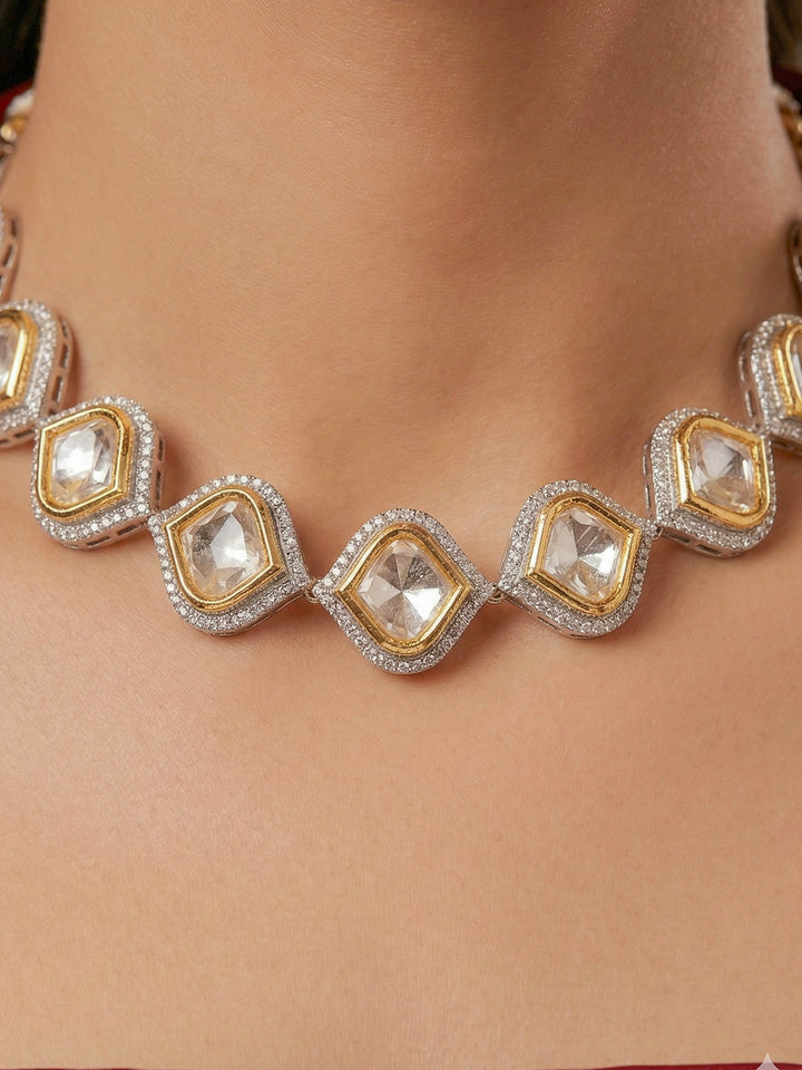 A women Wearing the Moissanite Susan Necklace Set—gold and silver Kundan necklace surrounded by American Diamonds, with matching earrings—gazing neutrally at the camera, effortlessly highlighting this luxury jewelry. Woman wearing trending Kundan artificial jewelry for wedding season in India. Festive saree styling with a premium artificial Kundan necklace.