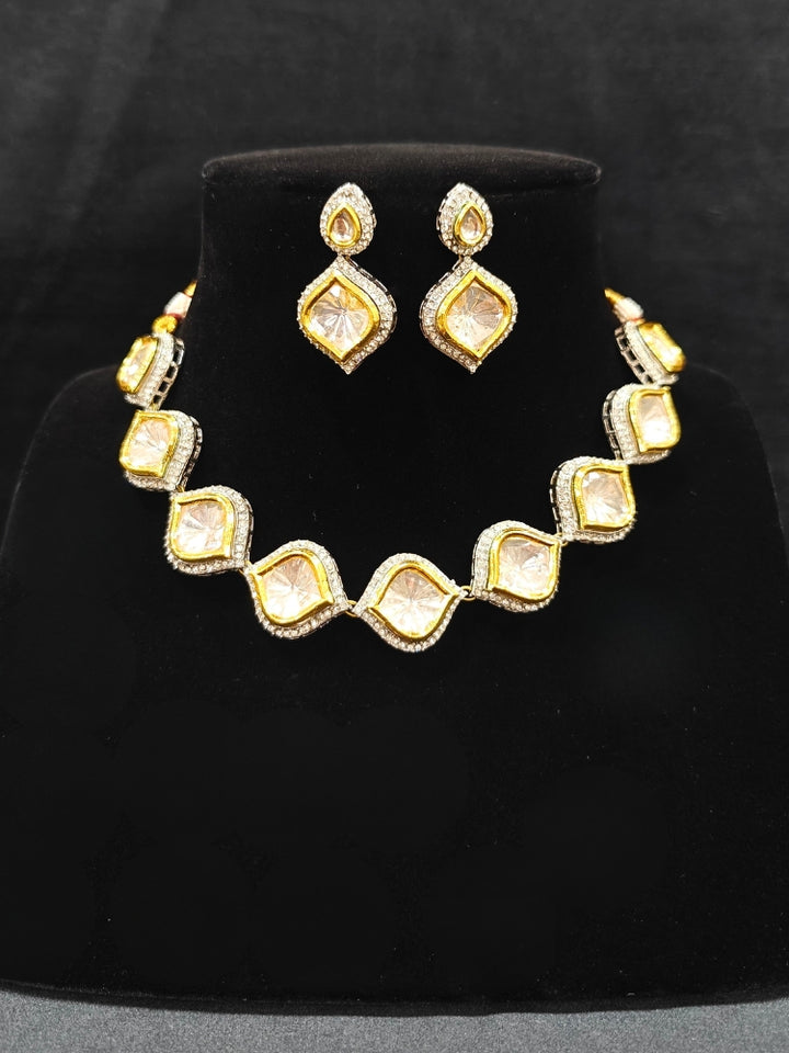 The Moissanite Susan Necklace Set—gold and silver Kundan necklace surrounded by American Diamonds, with matching earrings—gazing neutrally at the camera, effortlessly highlighting this luxury jewelry. Woman wearing trending Kundan artificial jewelry for wedding season in India. Festive saree styling with a premium artificial Kundan necklace.