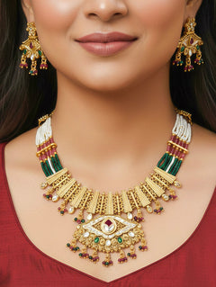 Close-up of a woman wearing an ornate traditional (Gold Polish) Pink & Green Collar jewellery set and earrings with Crystal Beads, Meenakari, Pearl and Colored Stone. Bride wearing a high-quality artificial Meenakari jewelry set for wedding rituals. Woman wearing lightweight artificial Meenakari jewelry for long wedding functions.