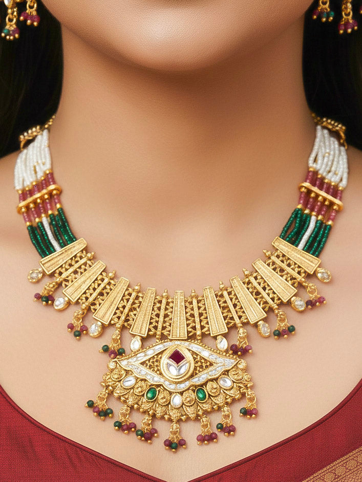 Close-up of a woman wearing an ornate traditional (Gold Polish) Pink & Green Collar jewellery set and earrings with Crystal Beads, Meenakari, Pearl and Colored Stone. Bride wearing a high-quality artificial Meenakari jewelry set for wedding rituals. Woman wearing lightweight artificial Meenakari jewelry for long wedding functions.