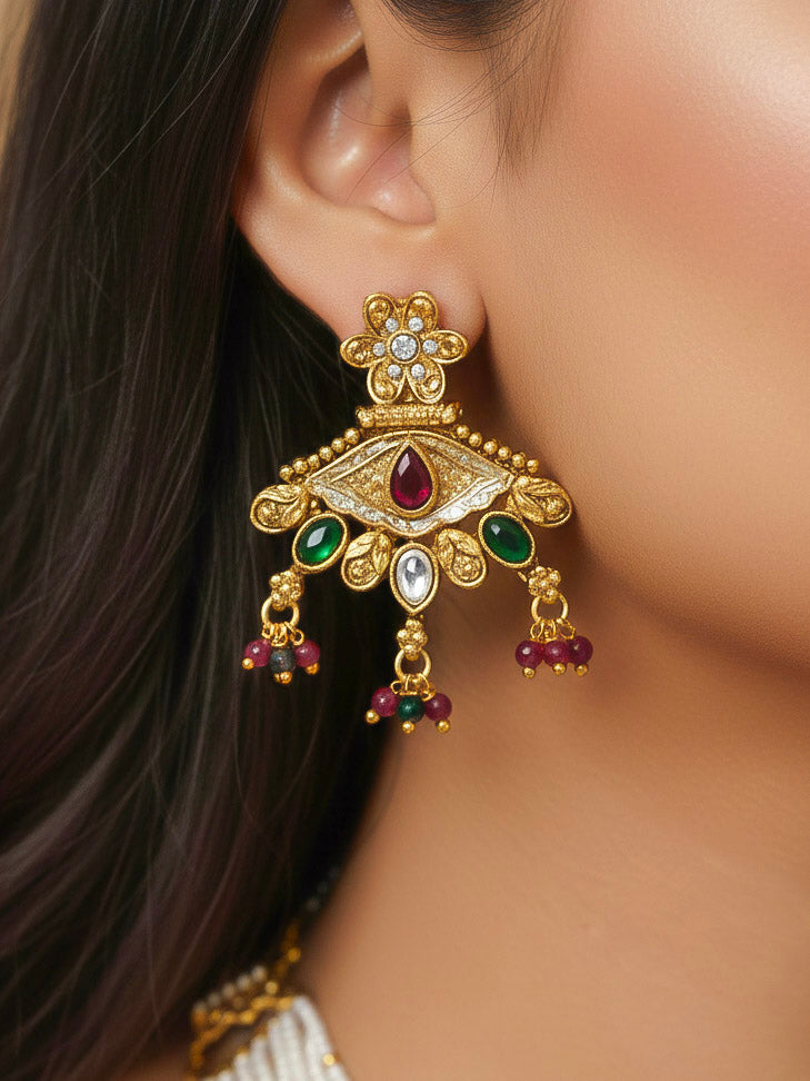 Close-up of a woman wearing an ornate traditional (Gold Polish) Pink & Green Collar jewellery set and earrings with Crystal Beads, Meenakari, Pearl and Colored Stone. Bride wearing a high-quality artificial Meenakari jewelry set for wedding rituals. Woman wearing lightweight artificial Meenakari jewelry for long wedding functions.