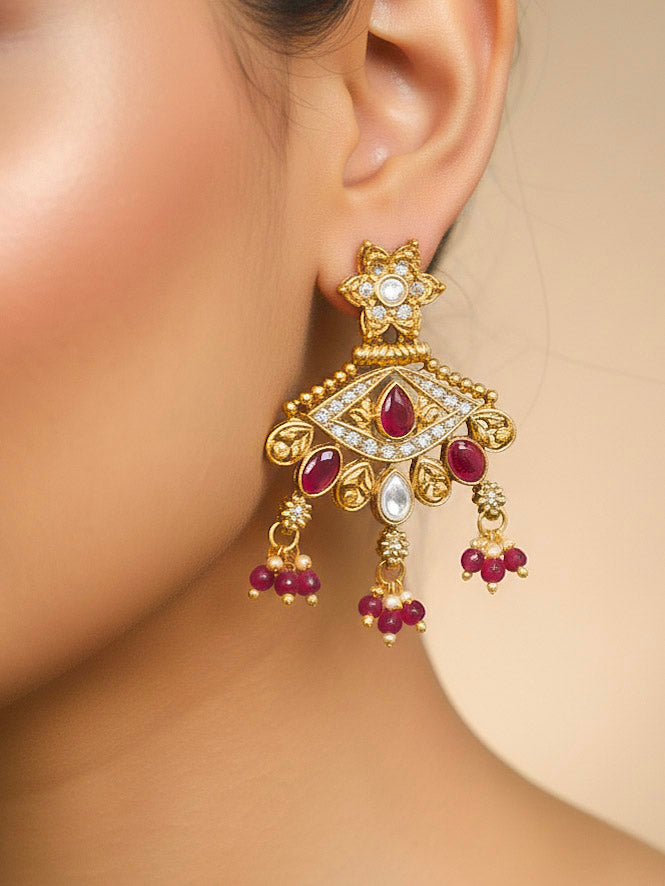 Close-up of a woman wearing an ornate traditional (Gold Polish) Pink Collar jewellery set and earrings with Crystal Beads, Meenakari, Pearl and Colored Stone. Bride wearing a high-quality artificial Meenakari jewelry set for wedding rituals. Woman wearing lightweight artificial Meenakari jewelry for long wedding functions.