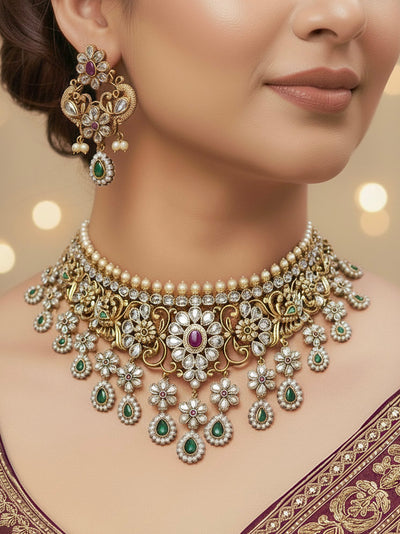 Close-up of a woman wearing an ornate traditional American Diamond gold Choker jewellery set and earrings with American Diamond Polki, Colored Stones and Pearls. A woman wearing a luxury American diamond necklace set styled beautifully for a wedding guest look in India. Close-up of a bridal look featuring an anti-tarnish American diamond artificial necklace.