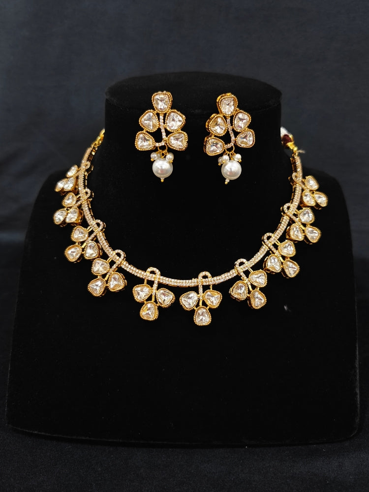 A sparkling artificial diamond and polki necklace and diamond earrings set, designed to offer a radiant, elegant look for any formal occasion or Indian wedding. This affordable diamond jewelry provides a flawless, luxurious alternative to natural diamonds.