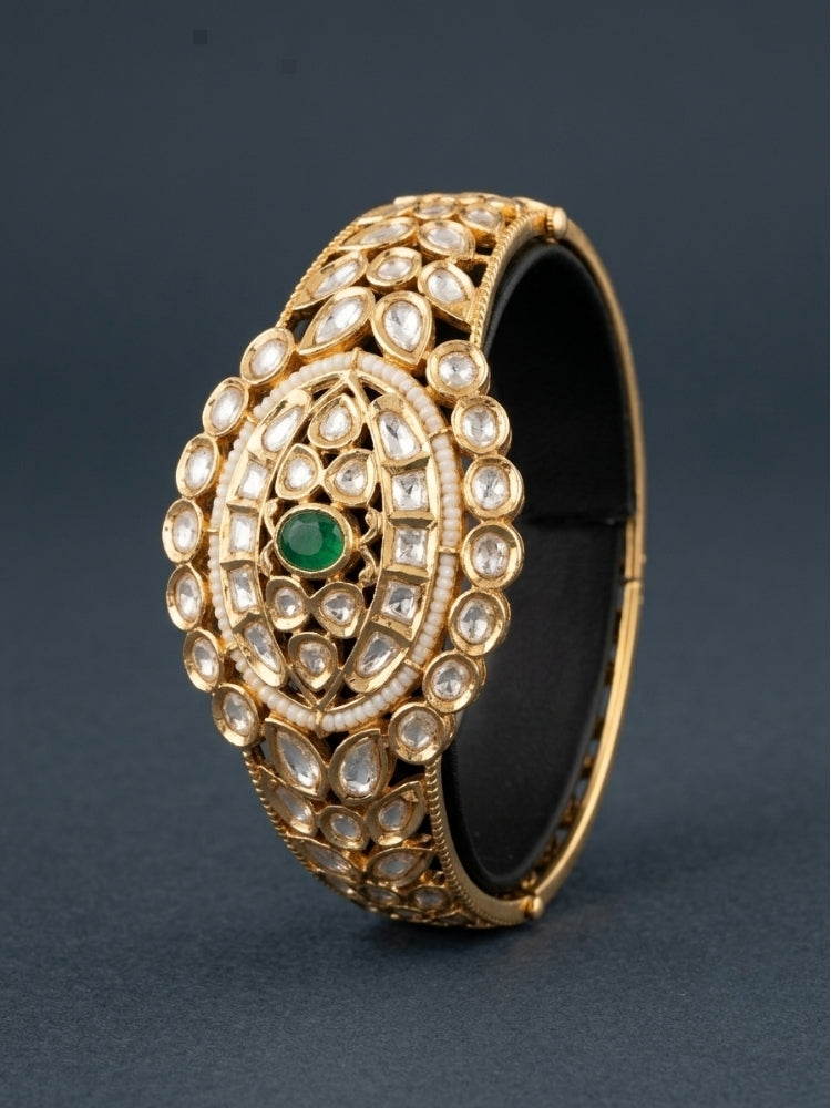 Close-up of an ornate traditional (Gold Polish) Green Bracelet with Polki, Green Colored Stone and Pearl. Wedding guest wearing a minimal artificial Polki bracelet. Close-up of a high-quality imitation Polki bracelet for festive wear.