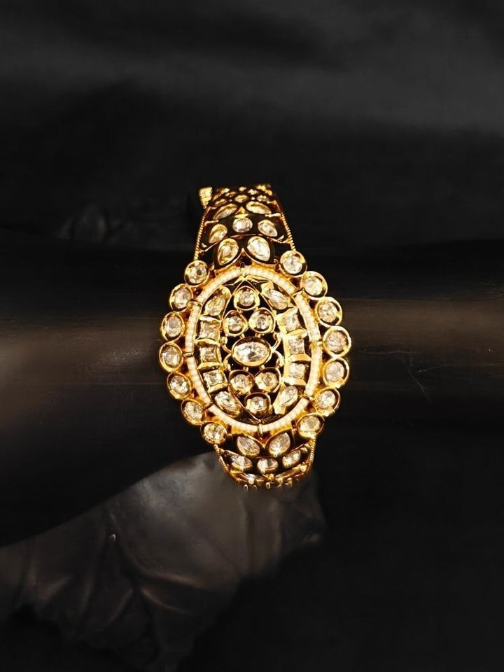 Close-up of an ornate traditional (Gold Polish) Ivory Bracelet with Polki and Pearl. Wedding guest wearing a minimal artificial Polki bracelet. Close-up of a high-quality imitation Polki bracelet for festive wear.
