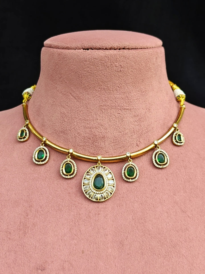 Close-up of an ornate Indo-western Dark Green (Dull gold) Hasli Diamond jewellery set and earrings with American Diamond and Colored Stones. Wedding guest wearing a sparkling American diamond necklace with a saree.
Close-up shot of a high-quality American diamond artificial necklace worn for festive celebrations.