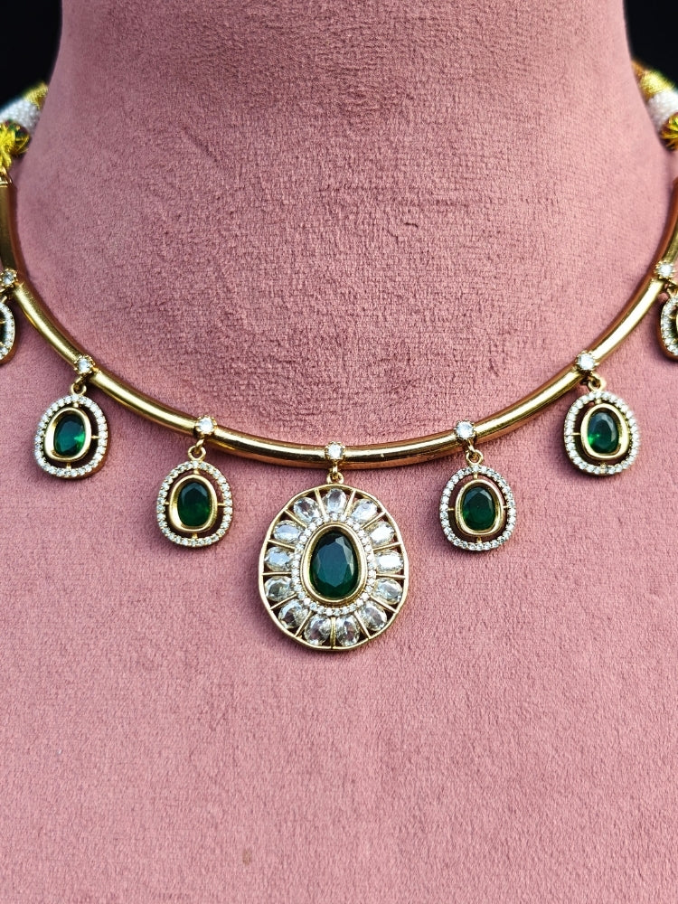 Close-up of an ornate Indo-western Dark Green (Dull gold) Hasli Diamond jewellery set and earrings with American Diamond and Colored Stones. Wedding guest wearing a sparkling American diamond necklace with a saree.
Close-up shot of a high-quality American diamond artificial necklace worn for festive celebrations.