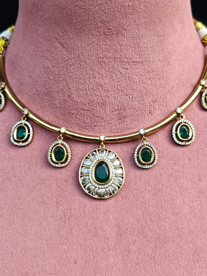 Close-up of an ornate Indo-western Dark Green (Dull gold) Hasli Diamond jewellery set and earrings with American Diamond and Colored Stones. Wedding guest wearing a sparkling American diamond necklace with a saree.
Close-up shot of a high-quality American diamond artificial necklace worn for festive celebrations.
