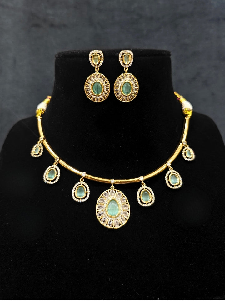 Close-up of an ornate Indo-western Mint Green (Dull gold) Hasli Diamond jewellery set and earrings with American Diamond and Colored Stones. Wedding guest wearing a sparkling American diamond necklace with a saree.
Close-up shot of a high-quality American diamond artificial necklace worn for festive celebrations.