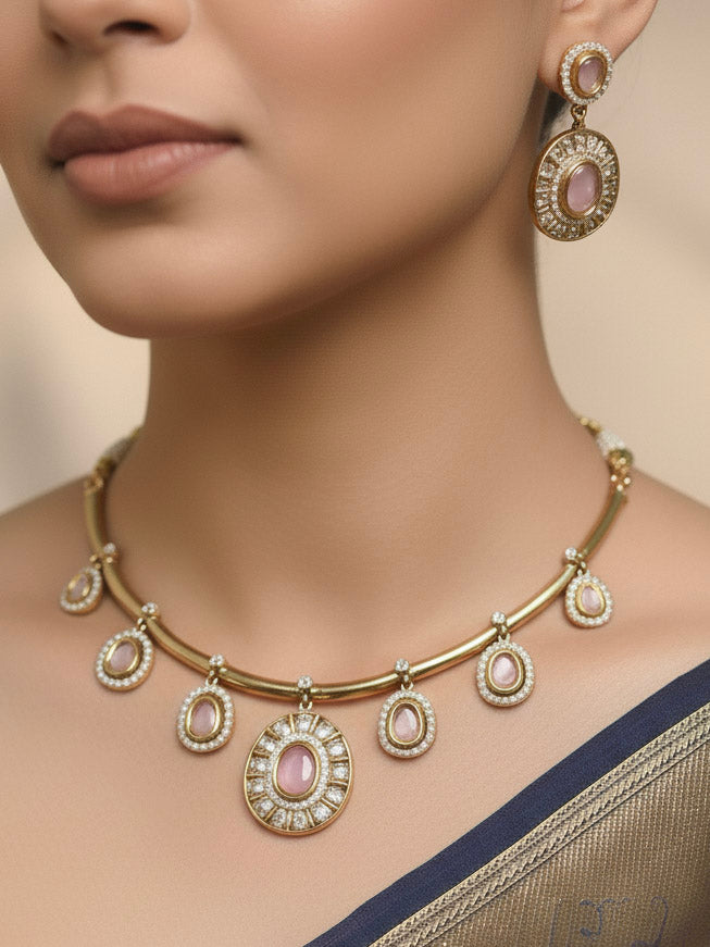 A woman wears the Tarunika mint pink Hasli Necklace Set, featuring a vibrant White hasli necklace with mint pink colored stone drops surrounded by american diamonds and matching earrings. The focus is on her striking jewelry.