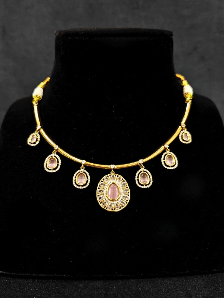 Close-up of an ornate Indo-western Mint Pink (Dull gold) Hasli Diamond jewellery set and earrings with American Diamond and Colored Stones. Wedding guest wearing a sparkling American diamond necklace with a saree.
Close-up shot of a high-quality American diamond artificial necklace worn for festive celebrations.