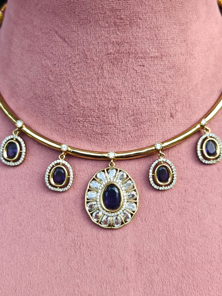 Close-up of an ornate Indo-western Purple (Dull gold) Hasli Diamond jewellery set and earrings with American Diamond and Colored Stones. Wedding guest wearing a sparkling American diamond necklace with a saree.
Close-up shot of a high-quality American diamond artificial necklace worn for festive celebrations.