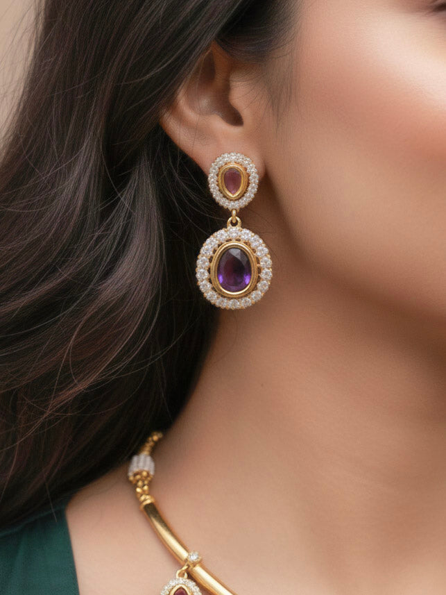 Close-up of a woman wearing an ornate Indo-western Purple (Dull gold) Hasli Diamond jewellery set and earrings with American Diamond and Colored Stones. Wedding guest wearing a sparkling American diamond necklace with a saree.
Close-up shot of a high-quality American diamond artificial necklace worn for festive celebrations.