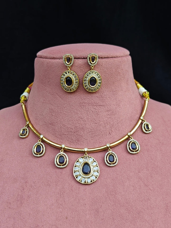 Close-up of an ornate Indo-western Purple (Dull gold) Hasli Diamond jewellery set and earrings with American Diamond and Colored Stones. Wedding guest wearing a sparkling American diamond necklace with a saree.
Close-up shot of a high-quality American diamond artificial necklace worn for festive celebrations.
