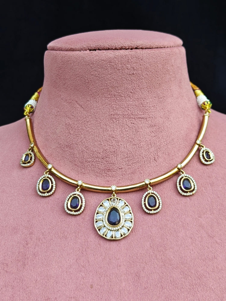 Close-up of an ornate Indo-western Purple (Dull gold) Hasli Diamond jewellery set and earrings with American Diamond and Colored Stones. Wedding guest wearing a sparkling American diamond necklace with a saree.
Close-up shot of a high-quality American diamond artificial necklace worn for festive celebrations.