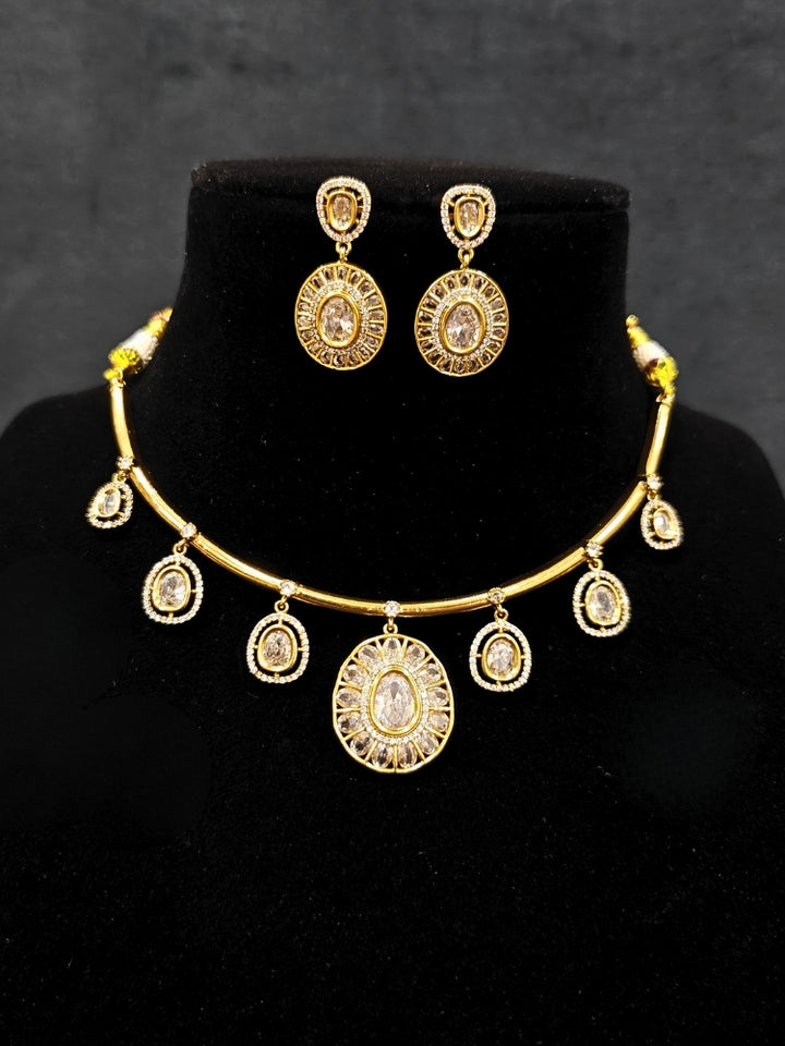Close-up of an ornate Indo-western White (Dull gold) Hasli Diamond jewellery set and earrings with American Diamond. Wedding guest wearing a sparkling American diamond necklace with a saree.
Close-up shot of a high-quality American diamond artificial necklace worn for festive celebrations.